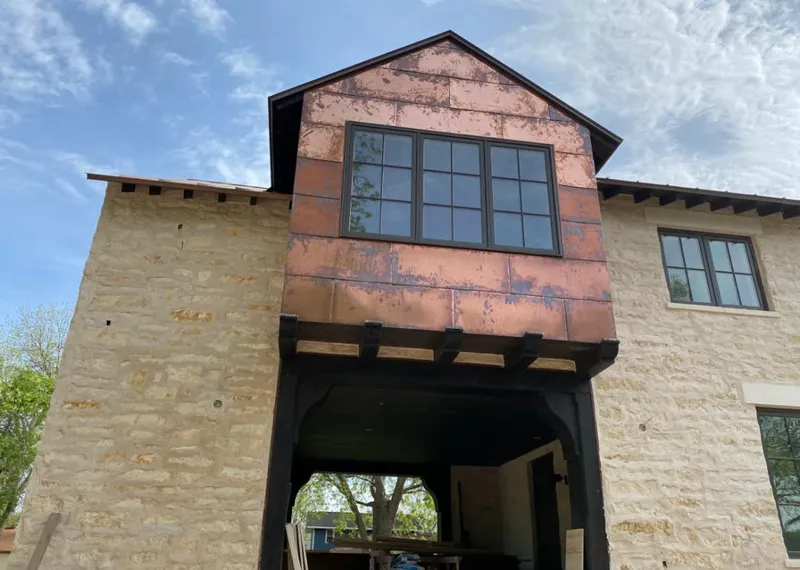 Copper metal panel facade on a stone building for Roof Repair in Salida